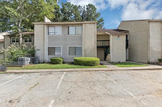 a house that has a tree in front of it