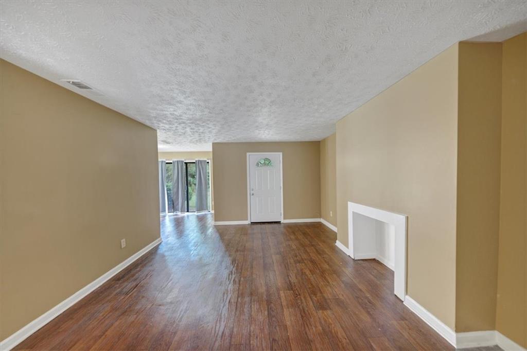 3575 Oakvale Road, Unit 302 Decatur, GA 30034 - Photo 2 of 10 a view of an empty room with wooden floor and window