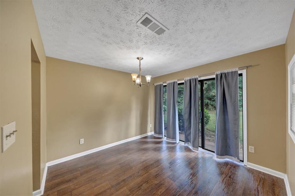 3575 Oakvale Road, Unit 302 Decatur, GA 30034 - Photo 3 of 10 wooden floor in an empty room with a window