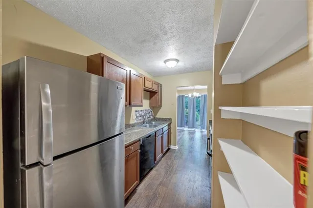 a kitchen with stainless steel appliances a refrigerator and a stove