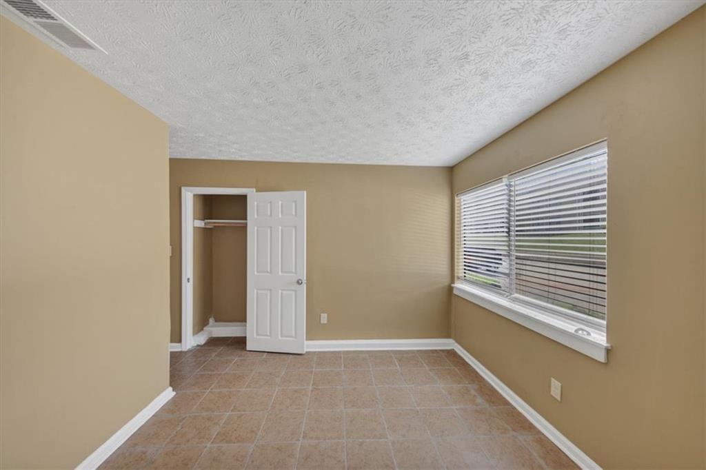 3575 Oakvale Road, Unit 302 Decatur, GA 30034 - Photo 8 of 10 a view of an empty room with a window