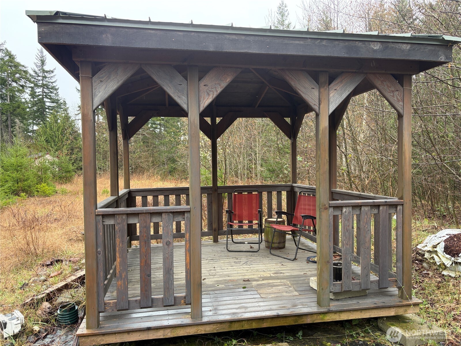 156 Whitney Road Quilcene, WA 98376 - Photo 22 of 36 a view of roof deck with table and chairs and wooden floor