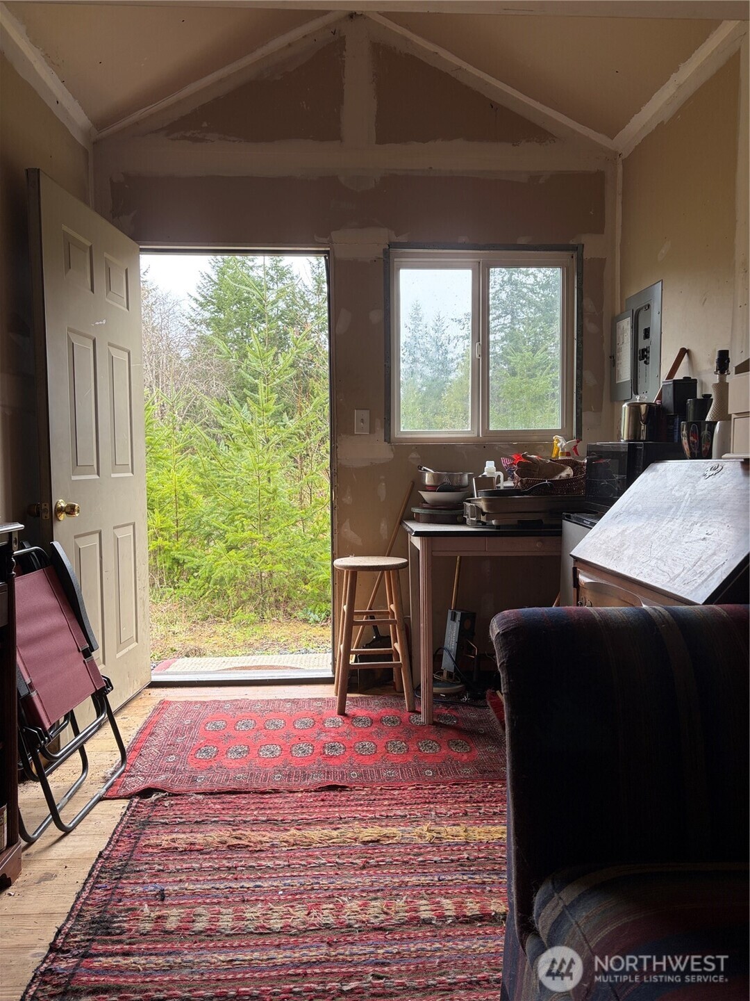 156 Whitney Road Quilcene, WA 98376 - Photo 7 of 36 a living room with furniture and a fireplace