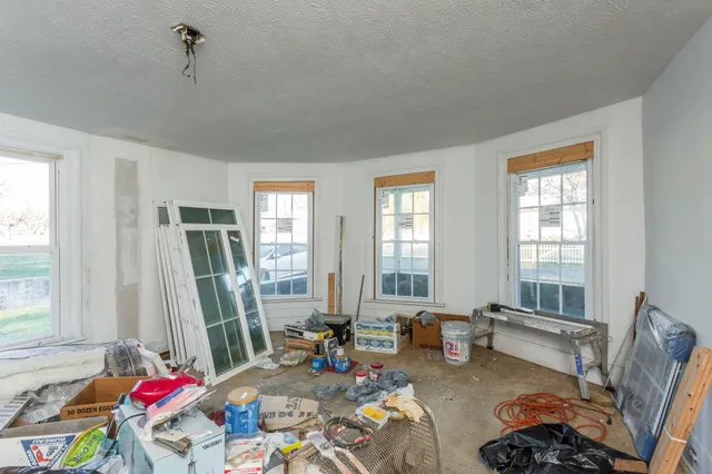 a living room with furniture and floor to ceiling windows
