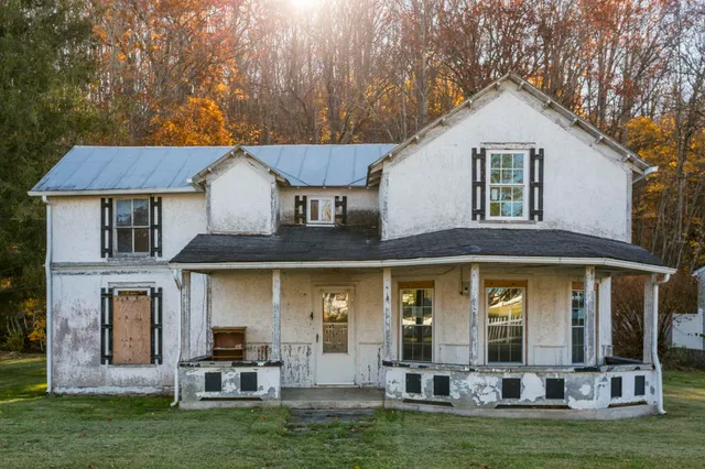 a front view of a house with a yard table and chairs