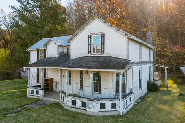 a front view of a house with a yard table and chairs