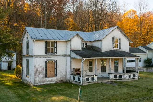a front view of a house with a yard table and chairs