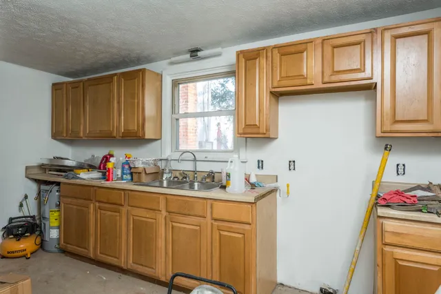 a kitchen with sink cabinets and window