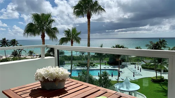 a view of a swimming pool with a patio and a garden