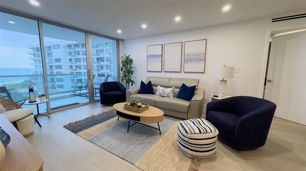 a living room with furniture and a large window