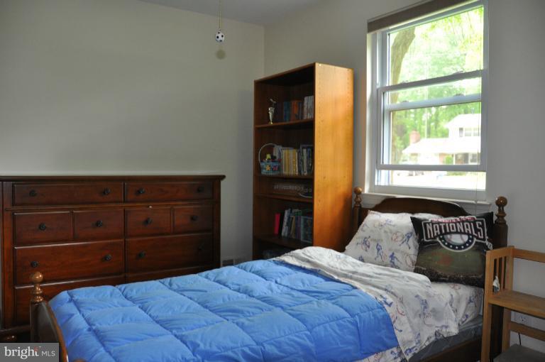 8612 Victoria Road Springfield, VA 22151 - Photo 11 of 25 a bedroom with a bed and a window