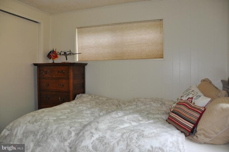 8612 Victoria Road Springfield, VA 22151 - Photo 12 of 25 a bedroom with a bed and a dresser in it