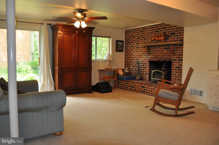 8612 Victoria Road Springfield, VA 22151 - Photo 15 of 25 a living room with furniture and a fireplace