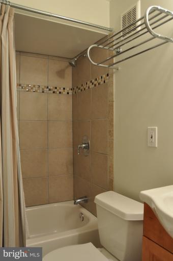 8612 Victoria Road Springfield, VA 22151 - Photo 21 of 25 a bathroom with a shower a toilet and sink