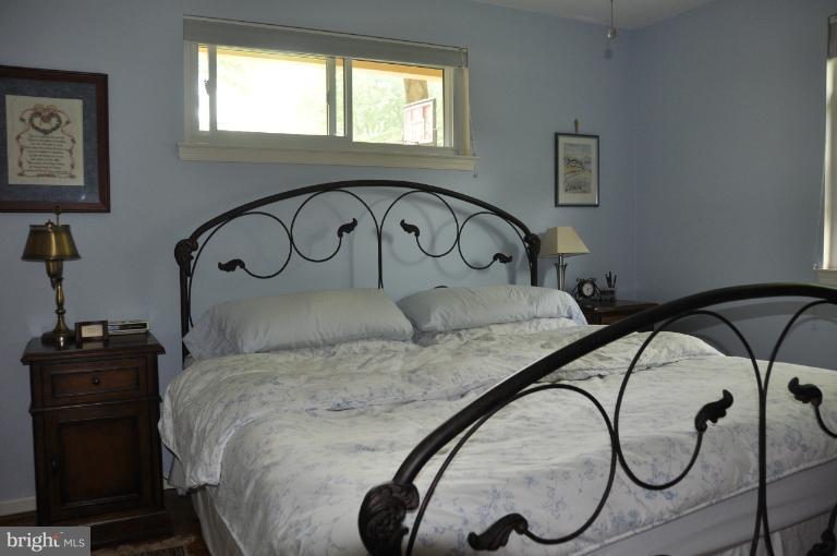 8612 Victoria Road Springfield, VA 22151 - Photo 6 of 25 a bedroom with a bed and a dresser next to a window