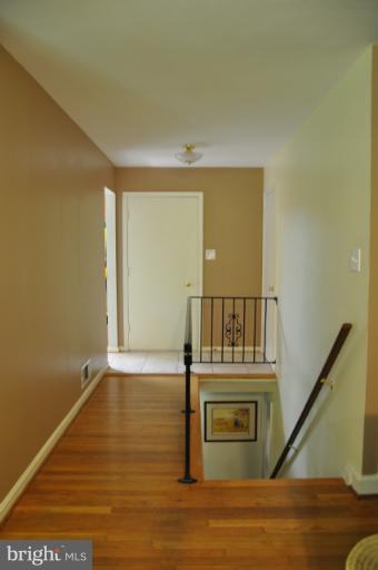 8612 Victoria Road Springfield, VA 22151 - Photo 8 of 25 a view of a livingroom with wooden floor and a floor to ceiling window