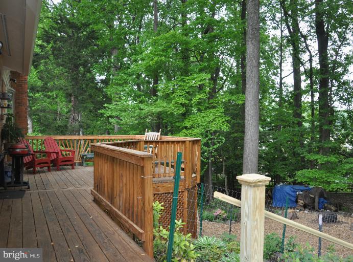 8612 Victoria Road Springfield, VA 22151 - Photo 9 of 25 a balcony with wooden floor and outdoor seating