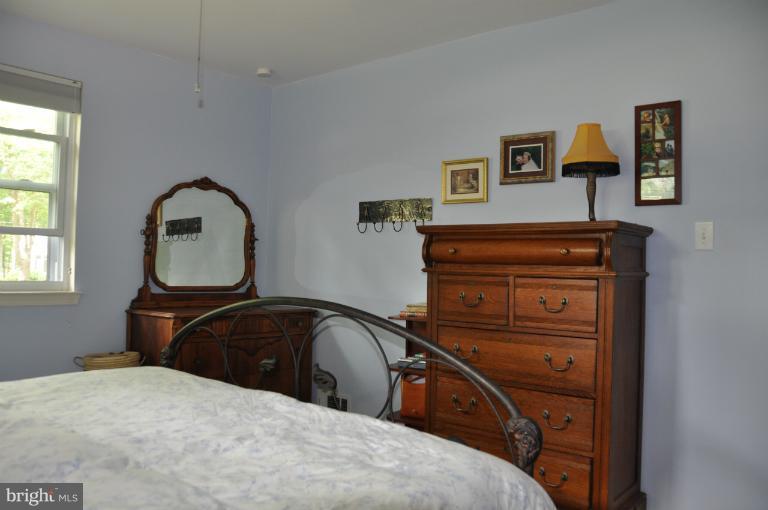 8612 Victoria Road Springfield, VA 22151 - Photo 10 of 25 a bedroom with a bed and a dresser