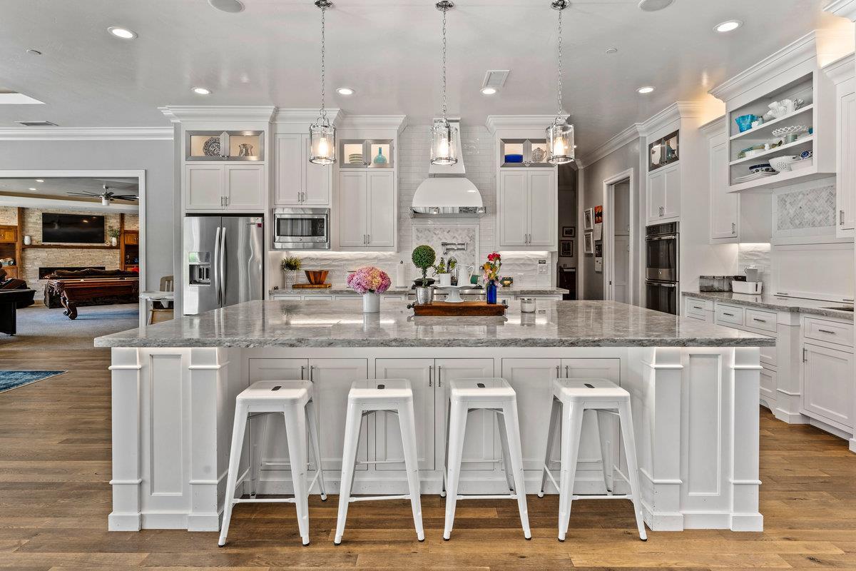 2165 West Biggs Gridley Road Gridley, CA 95948 - Photo 25 of 98 a kitchen with stainless steel appliances kitchen island granite countertop a table and chairs in it