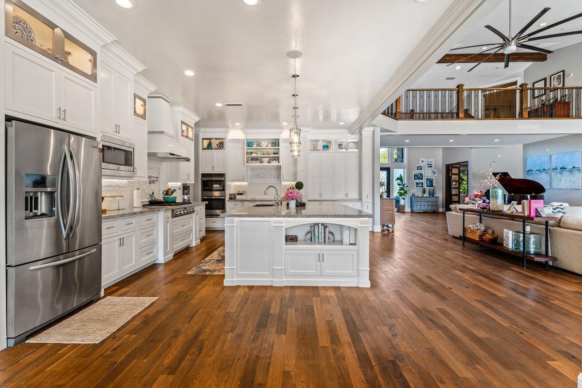 2165 West Biggs Gridley Road Gridley, CA 95948 - Photo 29 of 98 a kitchen with stainless steel appliances a stove top oven and a refrigerator
