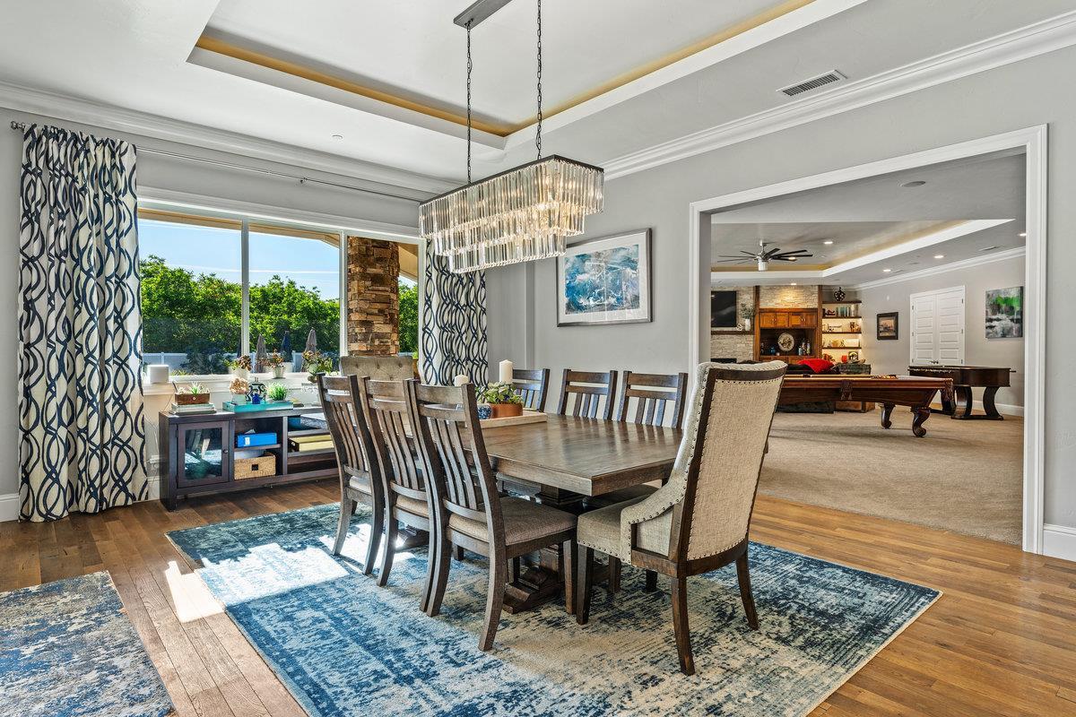 2165 West Biggs Gridley Road Gridley, CA 95948 - Photo 30 of 98 a dining room with furniture a rug a potted plant and a chandelier