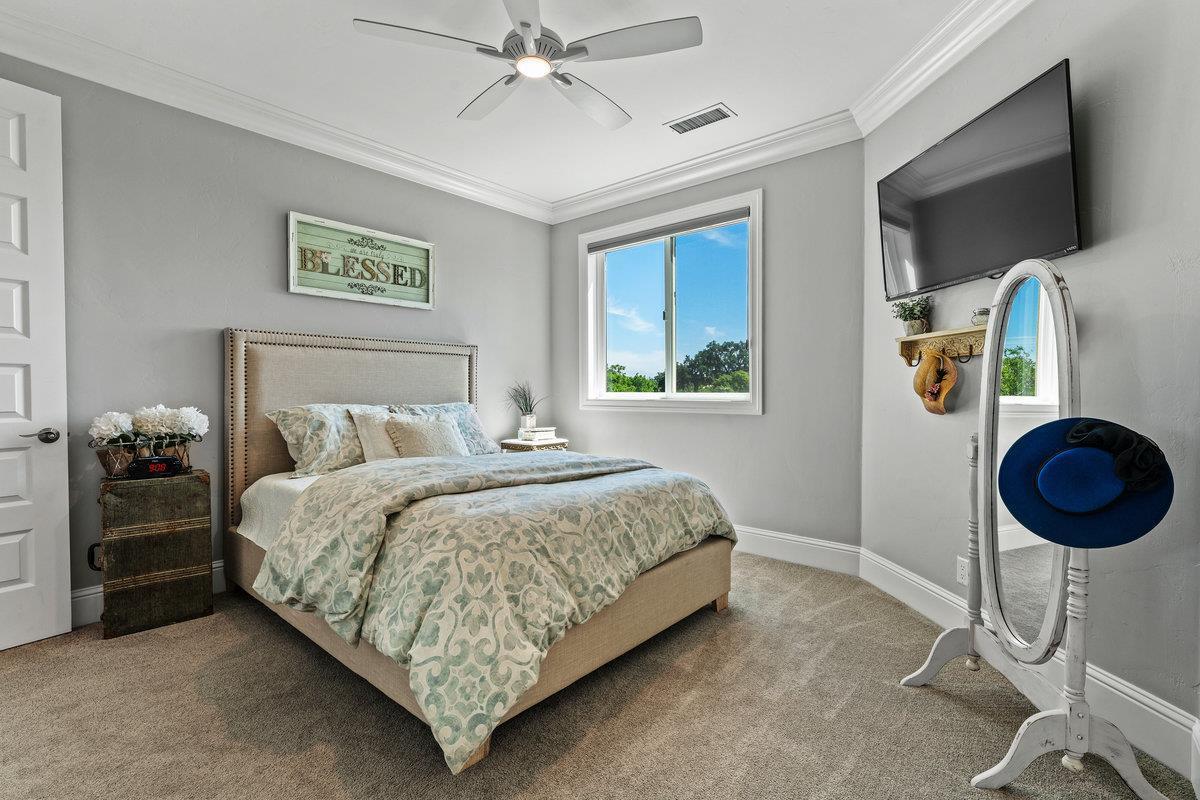 2165 West Biggs Gridley Road Gridley, CA 95948 - Photo 58 of 98 a bedroom with a bed and a chandelier