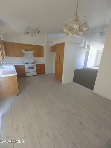 a kitchen with stainless steel appliances granite countertop a sink and a stove
