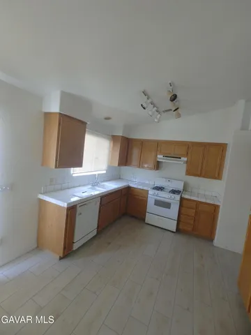 a kitchen with stainless steel appliances a sink and a refrigerator
