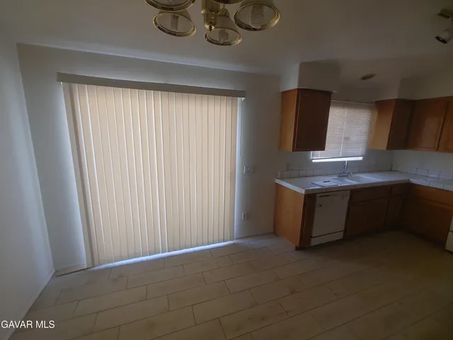 a view of empty room with window and fireplace