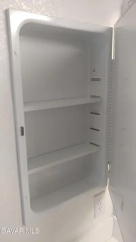 a view of a room with a ceiling fan