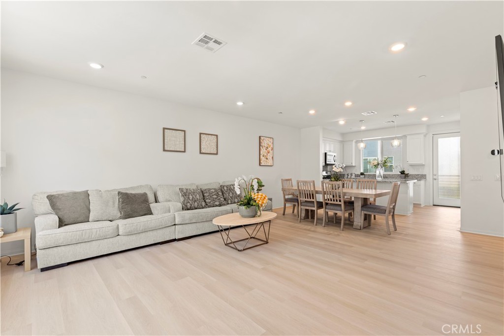 185 Steely Irvine, CA 92614 - Photo 15 of 28 a living room with furniture and a dining table with kitchen view