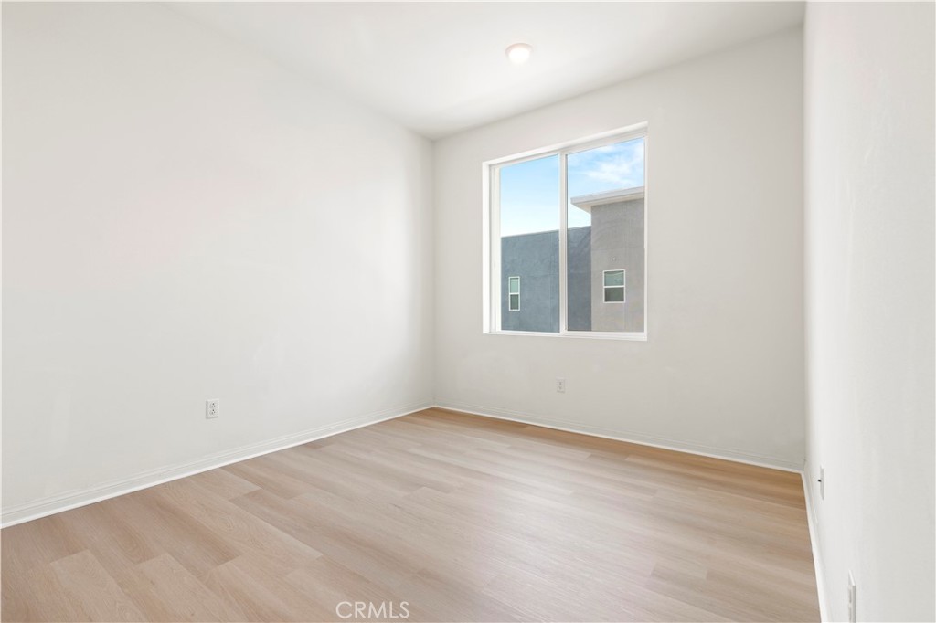 185 Steely Irvine, CA 92614 - Photo 22 of 28 an empty room with wooden floor and windows