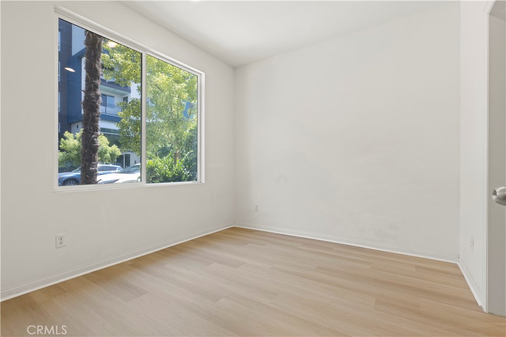 185 Steely Irvine, CA 92614 - Photo 3 of 28 an empty room with wooden floor and windows