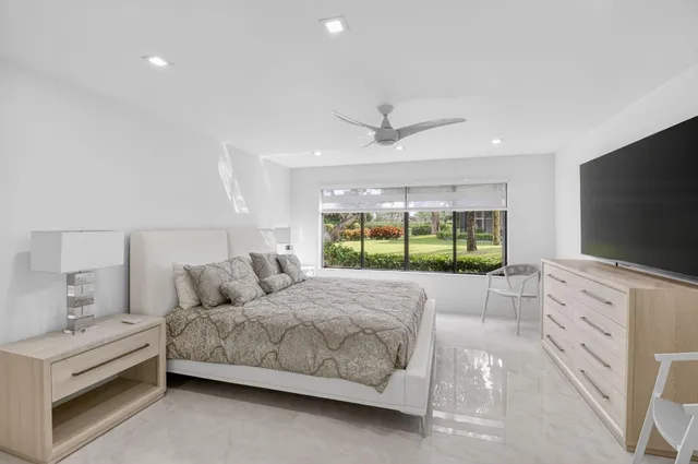 a view of a patio with a table and chairs and potted plants