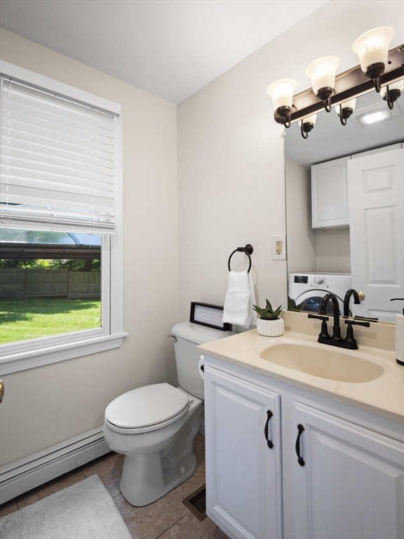 13 Plain Street Upton, MA 01568 - Photo 14 of 42 a bathroom with a toilet a sink and mirror