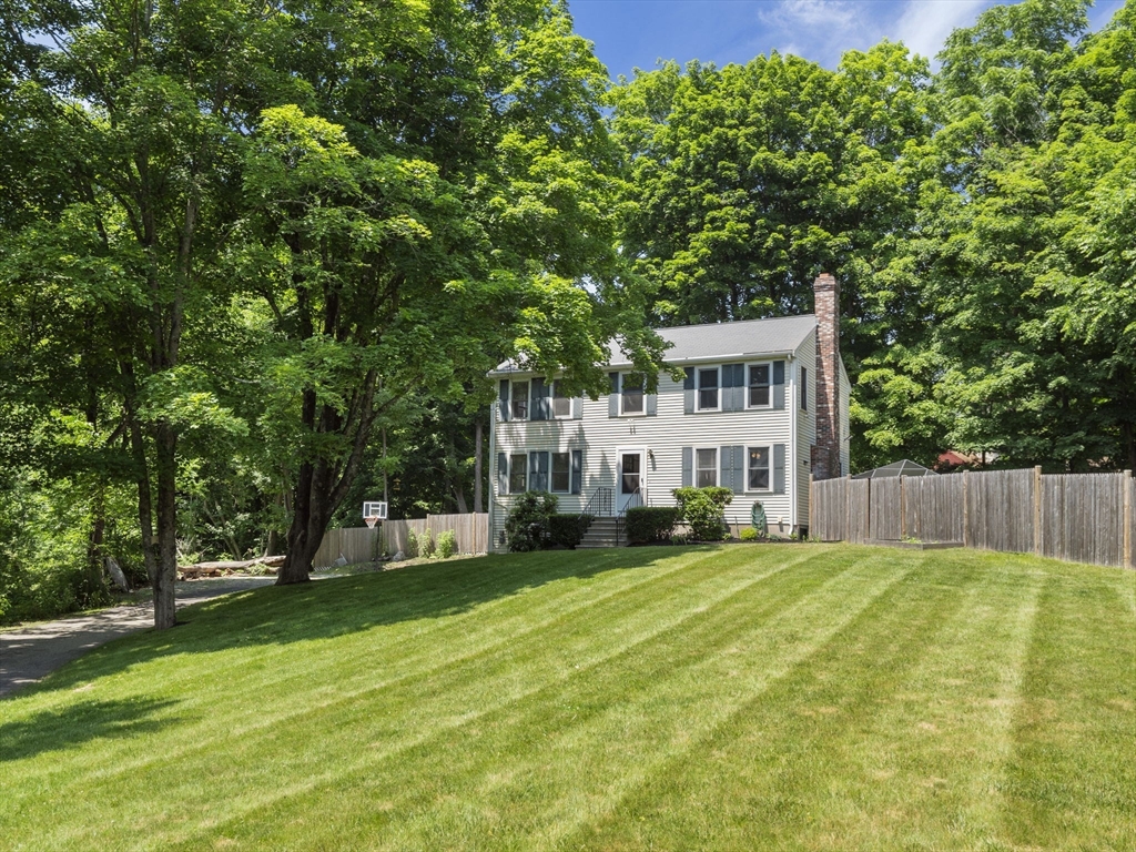 13 Plain Street Upton, MA 01568 - Photo 2 of 42 a view of a house with a big yard and large trees