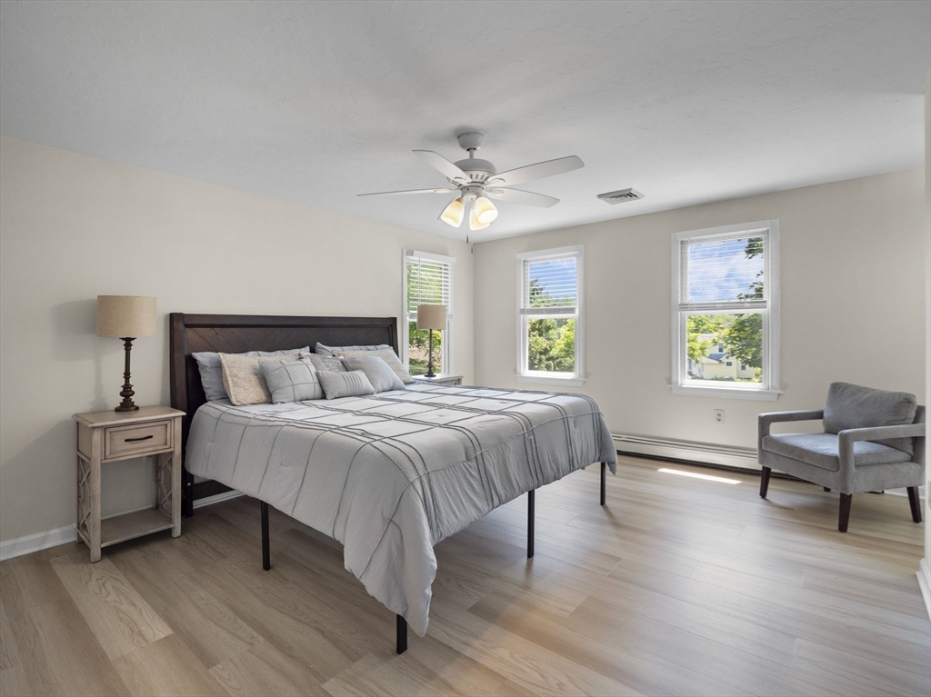 13 Plain Street Upton, MA 01568 - Photo 21 of 42 a bedroom with a bed and a chair