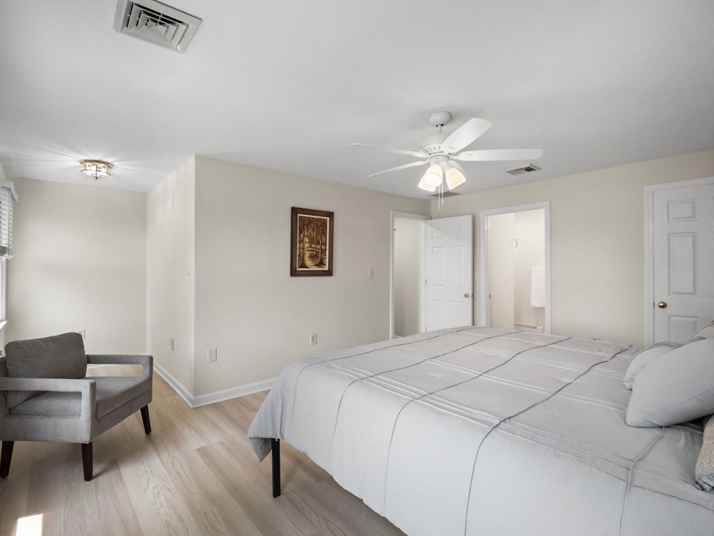 13 Plain Street Upton, MA 01568 - Photo 23 of 42 a bedroom with a large bed chandelier and a window