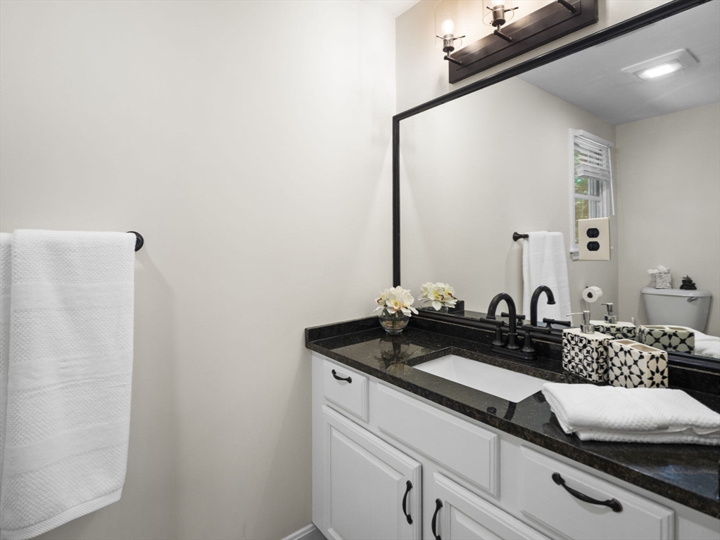 13 Plain Street Upton, MA 01568 - Photo 25 of 42 a close view of sink and mirror