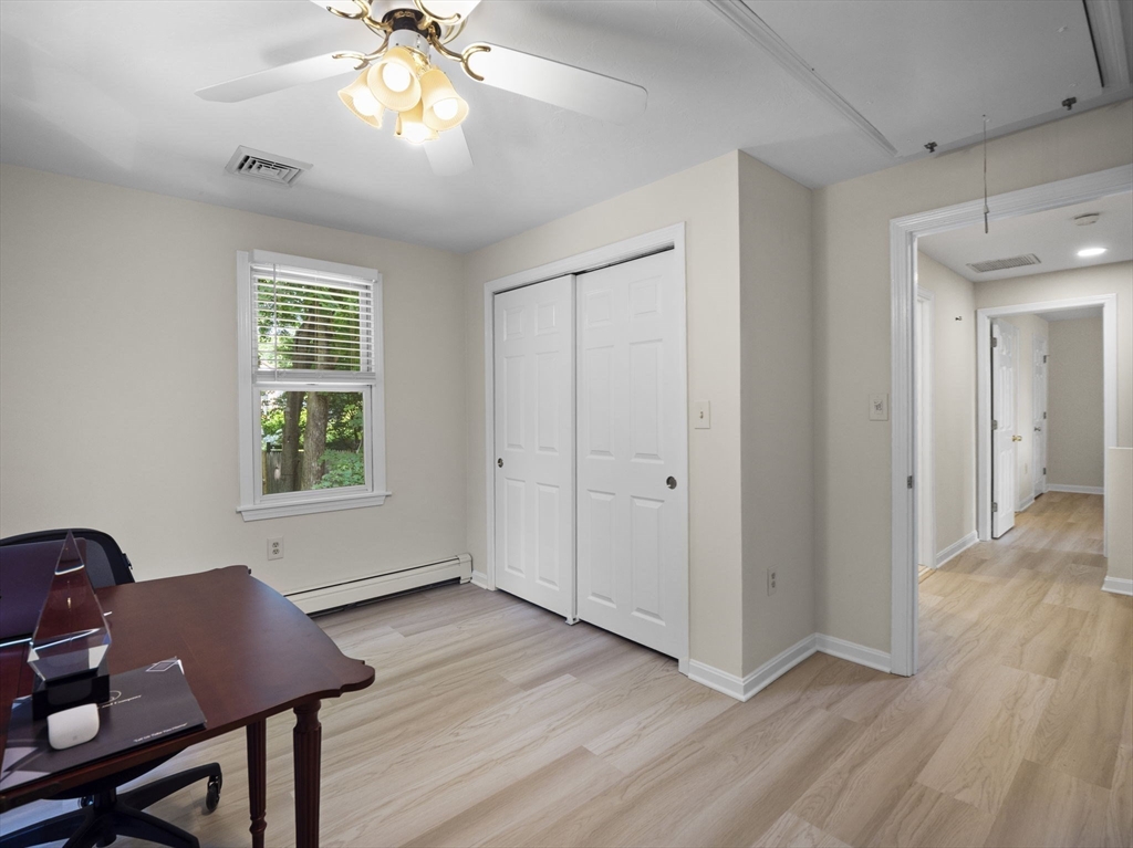 13 Plain Street Upton, MA 01568 - Photo 32 of 42 a view of an empty room with wooden floor and a window