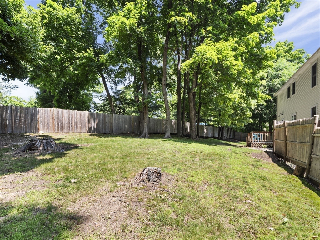 13 Plain Street Upton, MA 01568 - Photo 37 of 42 a backyard of a house with a garden and barbeque oven