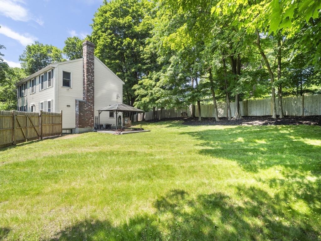 13 Plain Street Upton, MA 01568 - Photo 39 of 42 a view of a backyard with a small cabin