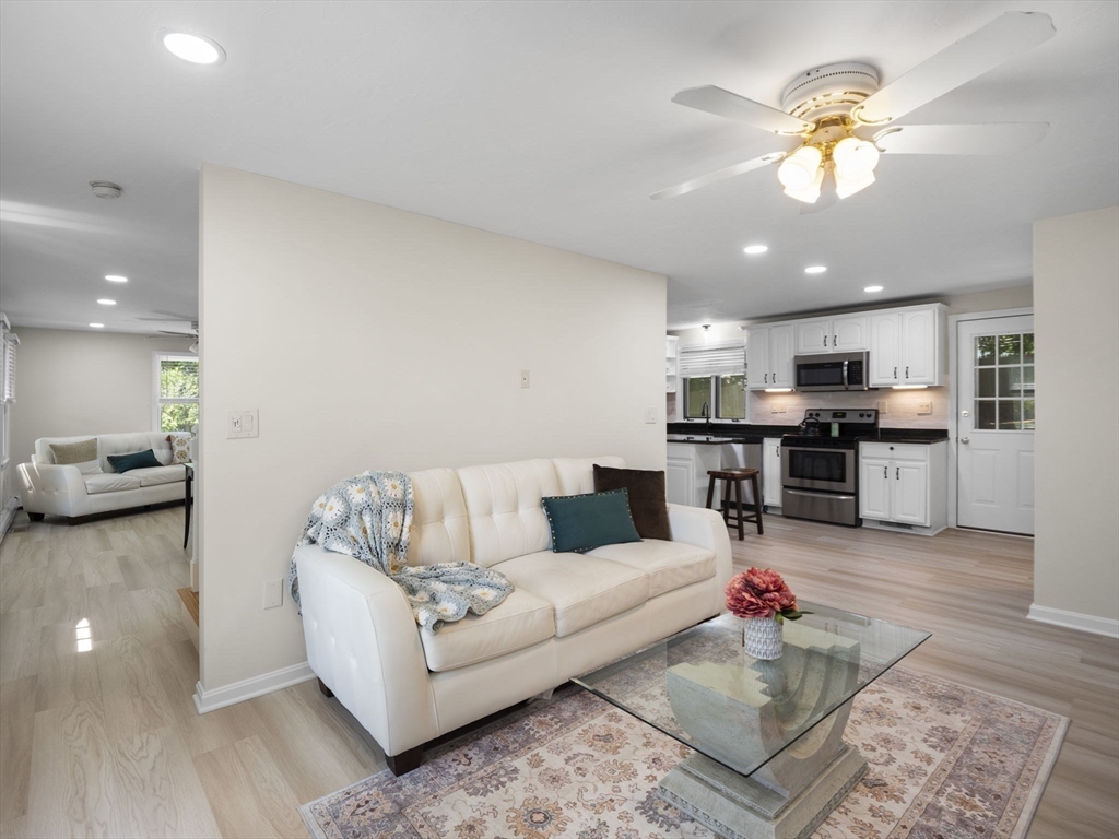 13 Plain Street Upton, MA 01568 - Photo 9 of 42 a living room with furniture and kitchen view