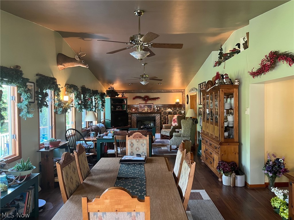 123 E Road Toronto, OH 43964 - Photo 7 of 34 Dining area with ceiling fan, vaulted ceiling, and dark wood-type flooring