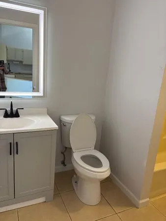 a white toilet sitting next to a bathroom sink