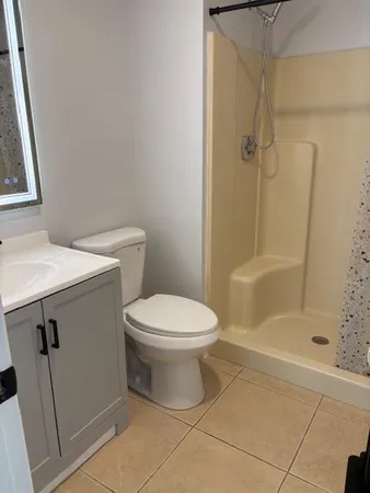 a bathroom with a toilet and shower