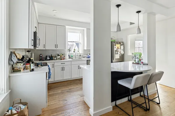 a kitchen with a sink cabinets and window