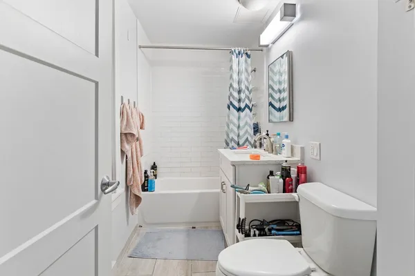 a bathroom with a sink toilet and shower