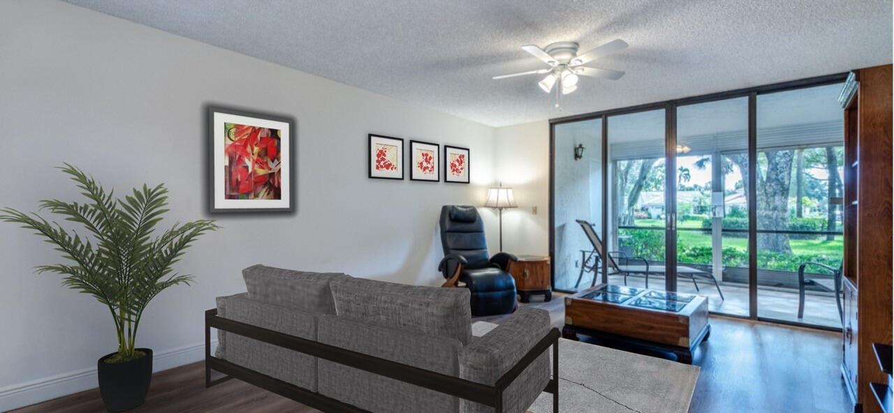 7527 Glendevon Lane, Unit 803 Delray Beach, FL 33446 - Photo 11 of 35 a living room with furniture and a large window with wooden floor