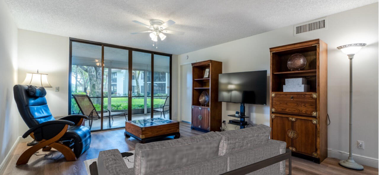 7527 Glendevon Lane, Unit 803 Delray Beach, FL 33446 - Photo 13 of 35 a bedroom with furniture and a large window